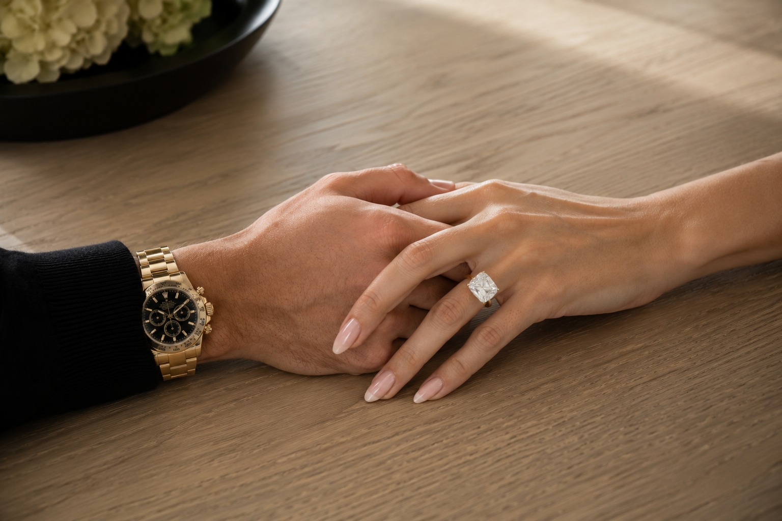 Intertwined hands in golden light representing Nicholas and Miriam Peters partnership